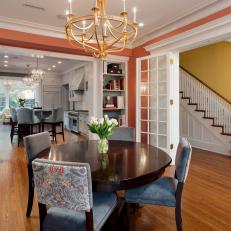 Orange Transitional Dining Room With Chandelier