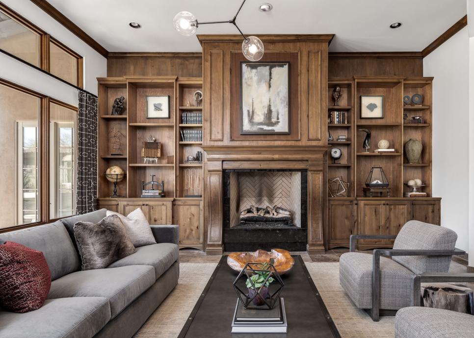 grand floor-to-ceiling fireplace with built-in bookshelves