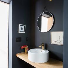 Black Powder Room With Wood Countertop