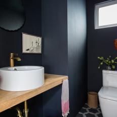 Black Powder Room With Red Mask