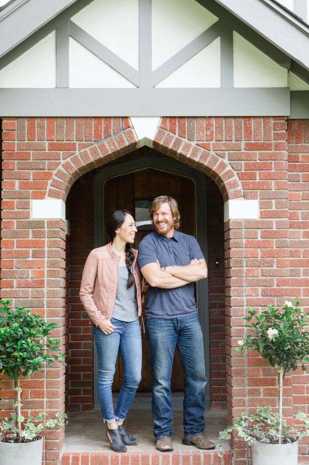 As seen on Fixer Upper, Chip and Joanna Gainesin front of the Scivano's remodeled home. (Portrait)