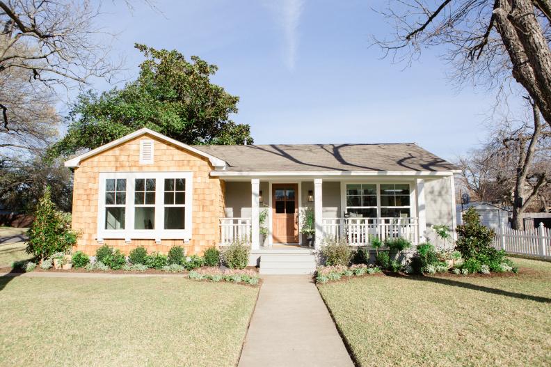 The exterior of the Baker's renovated home has new siding, landscaping and an updated porch, as seen on Fixer Upper. (After #1)