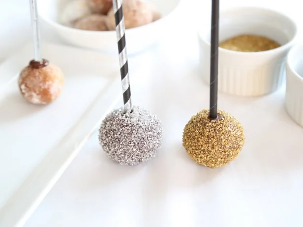 Repeat process with remaining donut holes using various metallic sugars and dragees. Allow to dry completely on the parchment paper, about 20 minutes. You may also speed setting by placing them in the refrigerator.