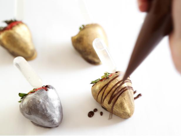 Transfer leftover chocolate to a piping bag with the end snipped and drizzle over berries, if desired. Let stand until set, about 15 minutes. Serve immediately or store in the refrigerator until ready to serve.