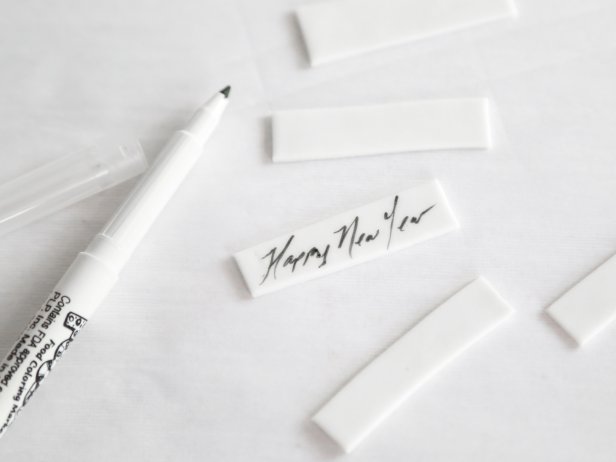 Use a food writer to pen “Happy New Year” and other messages on the fondant strips. 