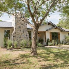 Contemporary Neutral Home Exterior with Gray Stone Chimney 
