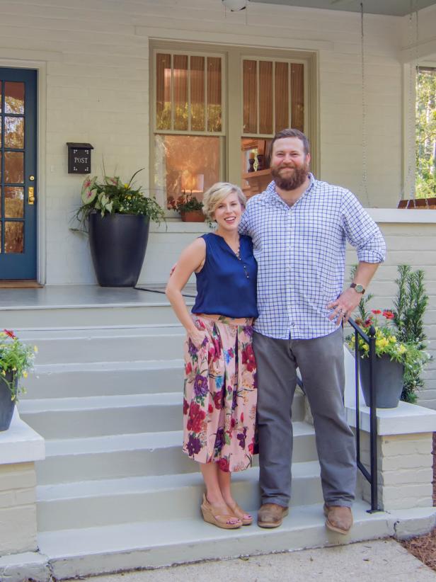 Hosts Ben and Erin Napier pose in front of the newly revealed Hurt house on Home Town