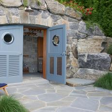Outdoor Storage Concealed in Natural Stone Archway With Blue Cottage French Door Entrance 