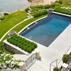 Grand Backyard Design Featuring Swimming Pool, Tiered Landscaped Yard and Shaped Shrubbery 