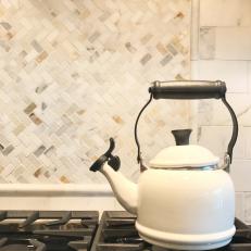 Tea Kettle on Stovetop With Herringbone Kitchen Backsplash