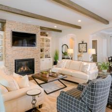Neutral Country Living Room With Fireplace and Ceiling Beams