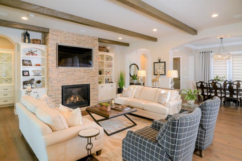 Country Living Room Has Ceiling Beams and Fireplace