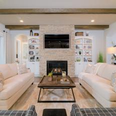 Neutral Transitional Living Room With Stone Fireplace Surround