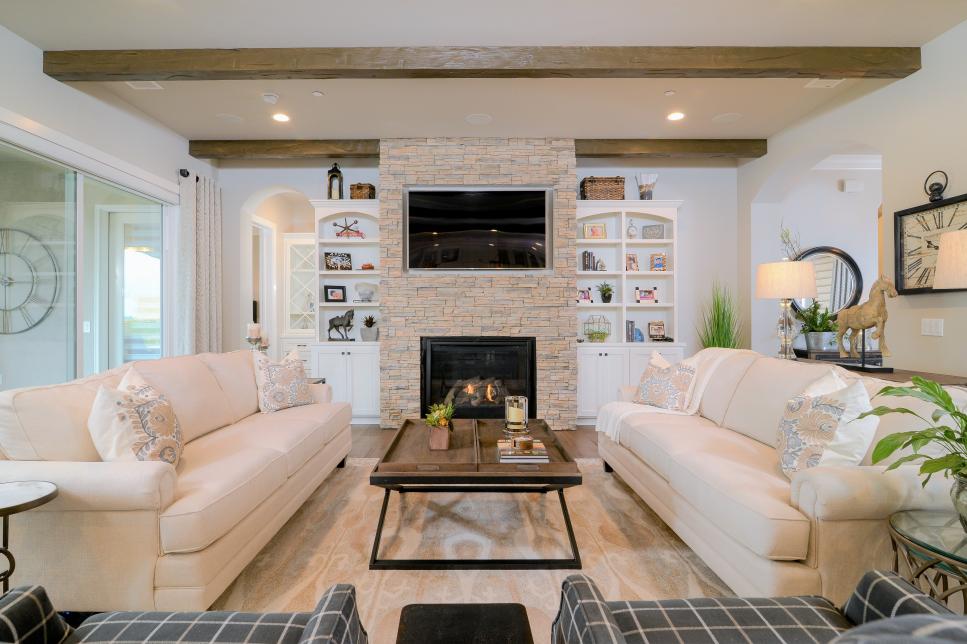 Living Room With Stone-Surround Fireplace and Exposed Ceiling Beams