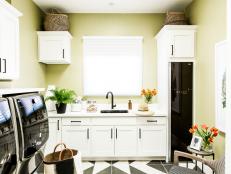 Stylish laundry room has Shaker-style cabinets and flat drawers