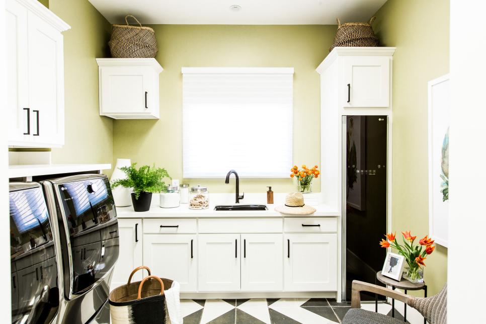 Stylish laundry room has Shaker-style cabinets and flat drawers