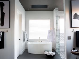 Master bathroom features an oval freestanding tub with digital filler