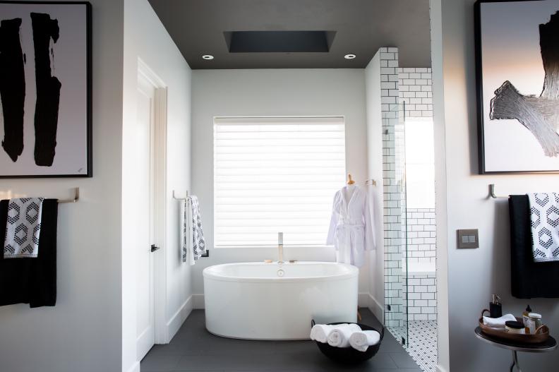 Master bathroom features an oval freestanding tub with digital filler