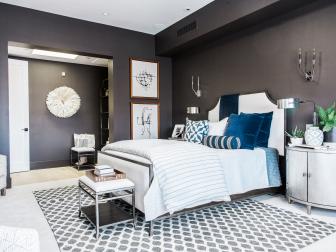 Master bedroom has charcoal walls, high-tech bed, oval nightstands