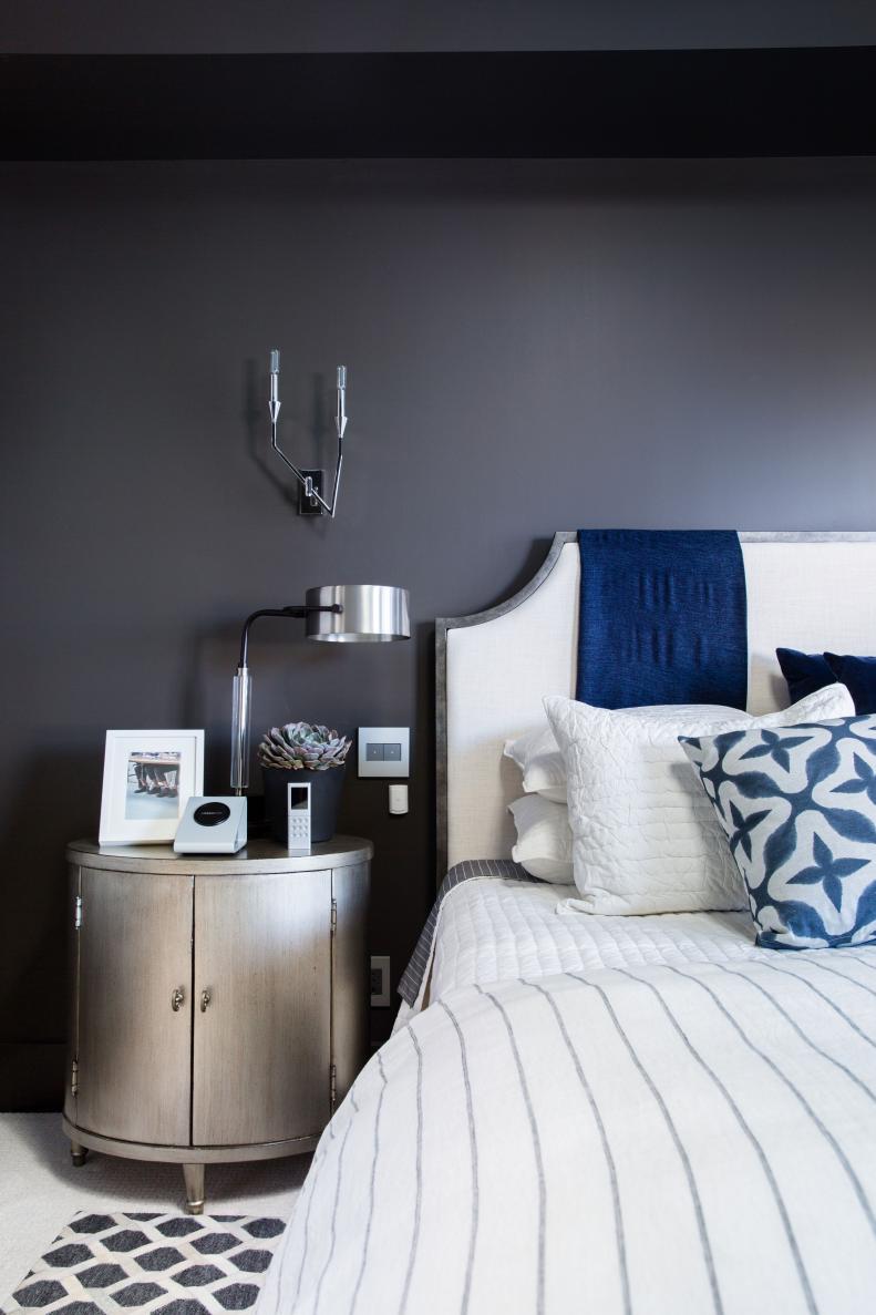 Oval nightstands are positioned on either side of the queen bed