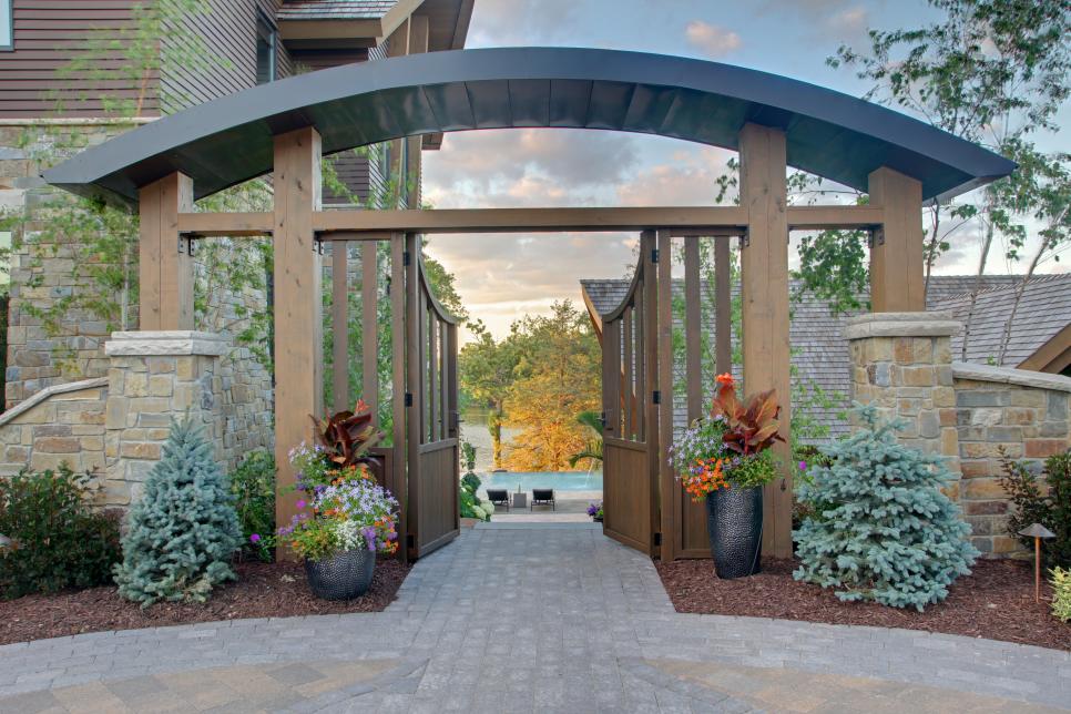 Contemporary Gate Leads to Patio and Pool Next to Lake