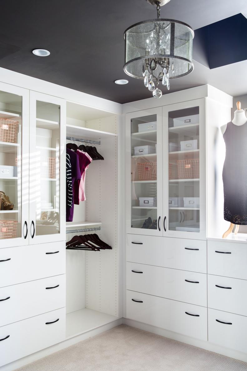 Master closet features easy-close drawers and glass-front cabinets
