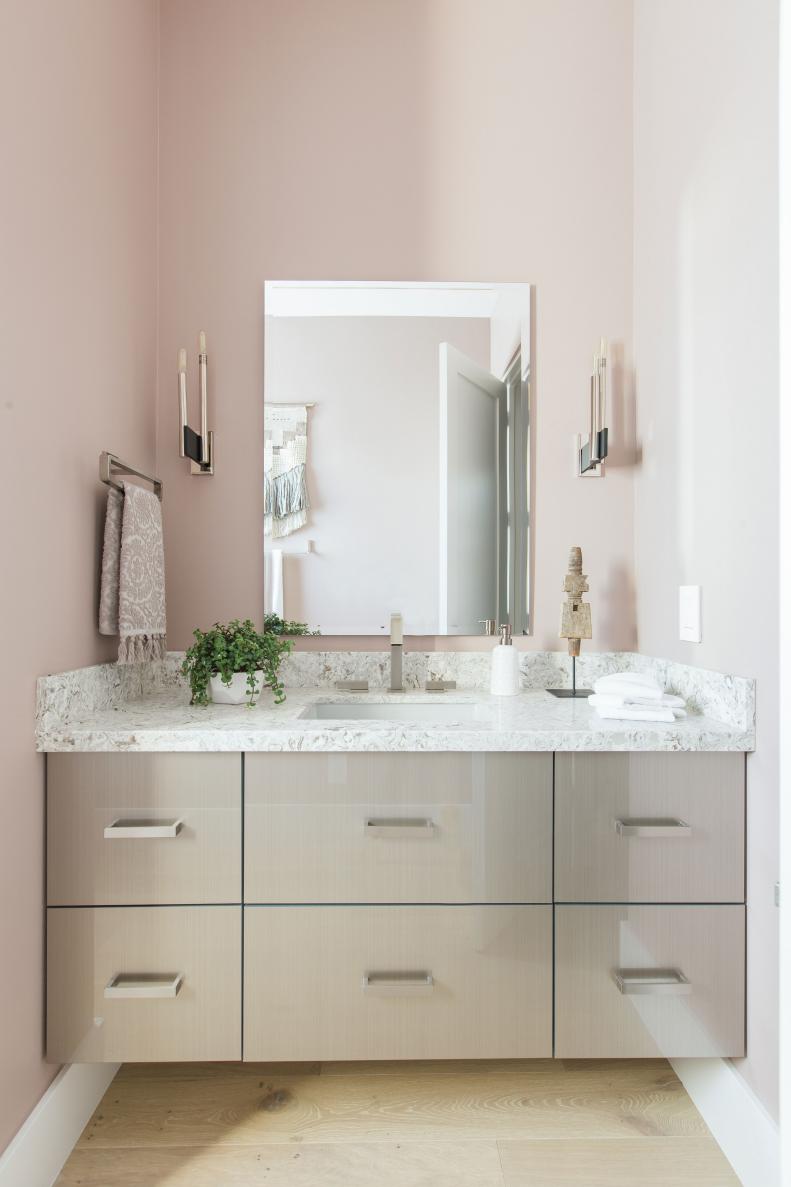 Taupe powder room features floating gray vanity with quartz countertop