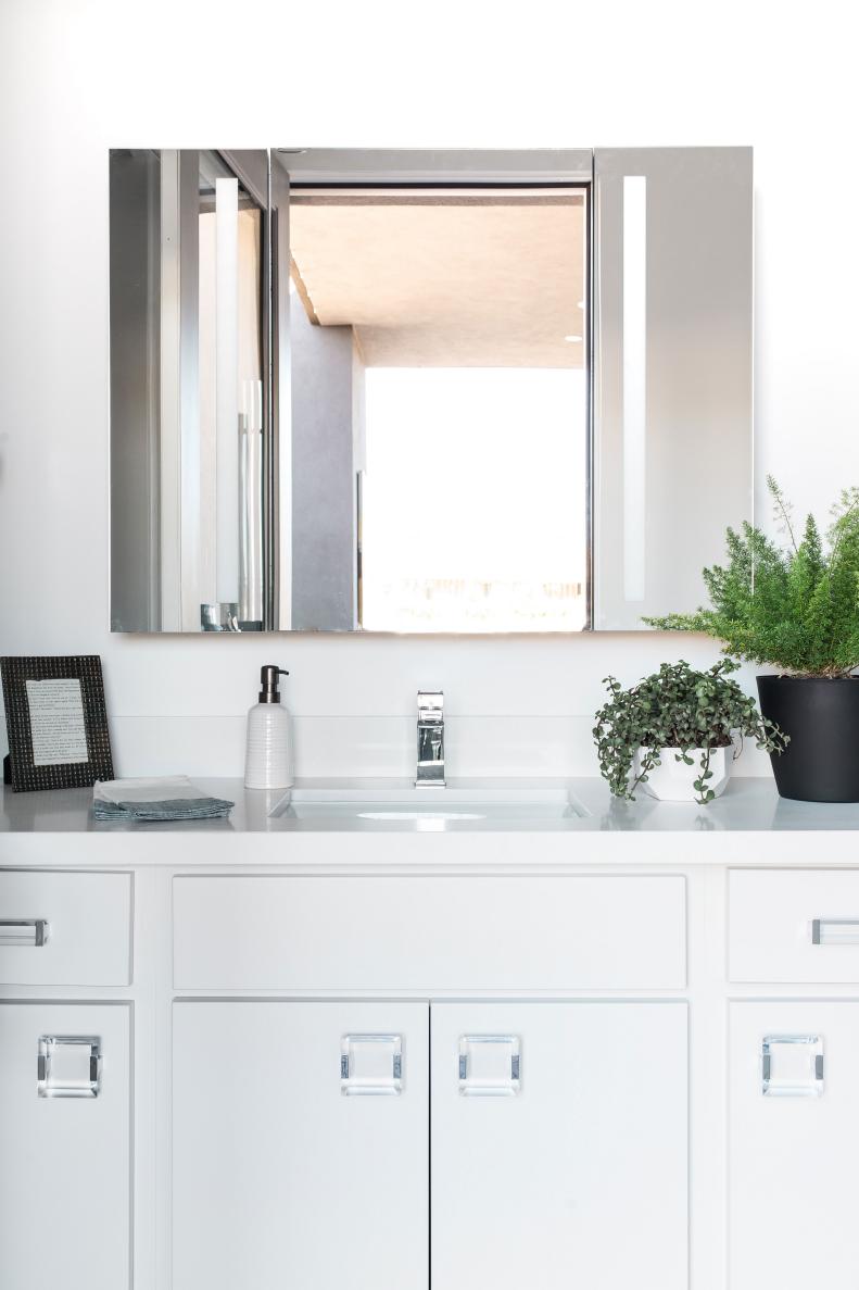 Clean-lined white vanity with maple cabinets and Lucite hardware