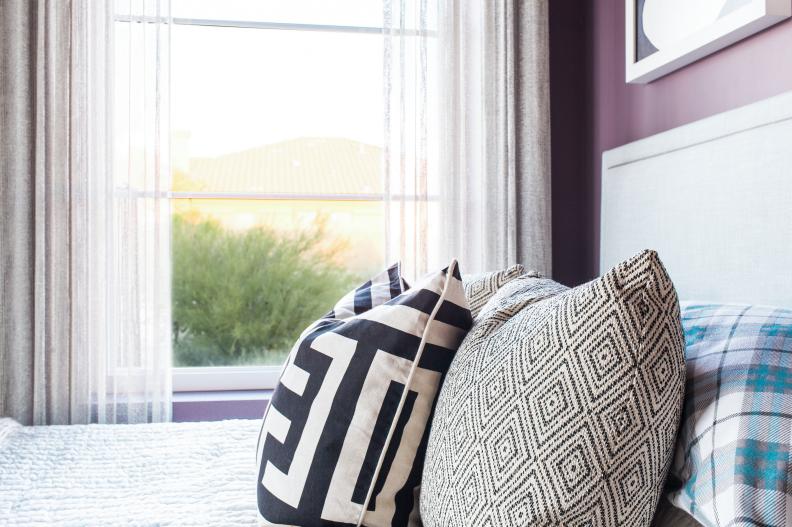 Accent pillows with graphic patterns add texture to full-size bed
