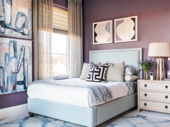 Sky-blue bed over blue and gray rug in violet bedroom