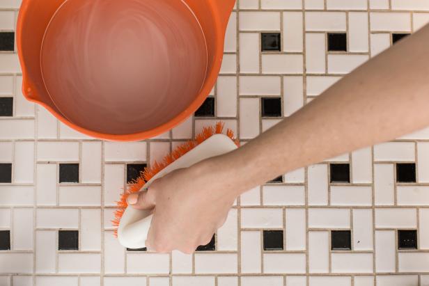 Baking soda paired with warm water and bleach will knock out stubborn grout stains on tile floors and walls. If you need a heavy-duty cleaning, amp up the bleach but wear gloves to protect that manicure.