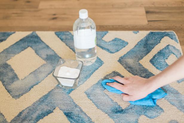 If you’ve got an unsightly spot on a rug or carpet, sprinkle it with baking soda to wick out any excess moisture. Let it sit for a few minutes, then vacuum it up. Next, blot the stain with 1 cup warm water mixed with 1 tablespoon vinegar working from the outside edges inward. Blot until the stain has transferred from the carpet to the cleaning cloth and allow to air dry.