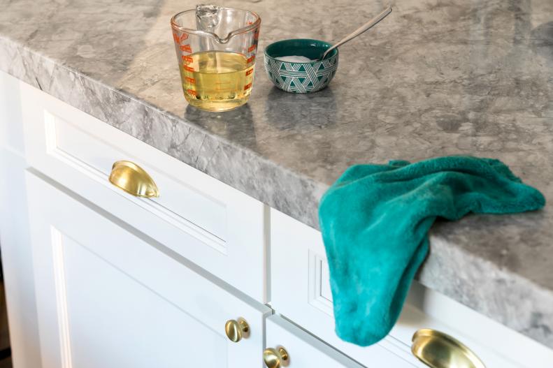 Kitchen and bath cabinets take a beating. Get them extra clean with a light scrub of ½ cup vegetable oil and 1 cup baking soda. Wipe away cleaning mixture with a damp clean cloth. 