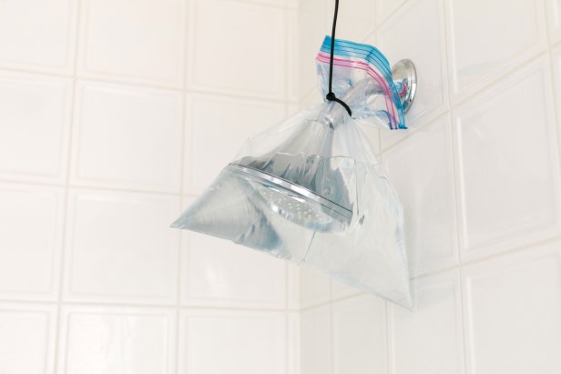 Mineral deposits and calcium build up can cause your shower head to clog up and look spotty.  Go the extra mile and submerge them in a plastic bag filled with warm white vinegar. Just be sure to fill the bag so that the fixture is completely submerged, then secure the bag with a zip tie or extra strong 