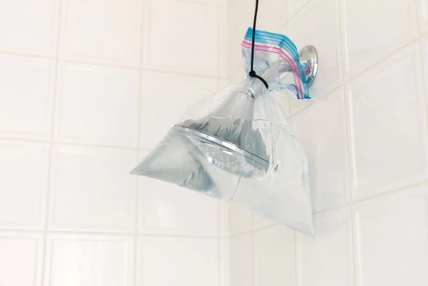 Mineral deposits and calcium build up can cause your shower head to clog up and look spotty.  Go the extra mile and submerge them in a plastic bag filled with warm white vinegar. Just be sure to fill the bag so that the fixture is completely submerged, then secure the bag with a zip tie or extra strong 