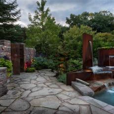 Flagstone Patio With Modern Water Feature and Pool