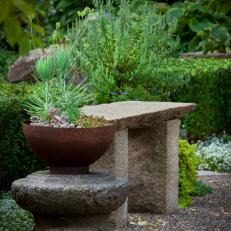 Inviting Stone Bench in Formal Garden