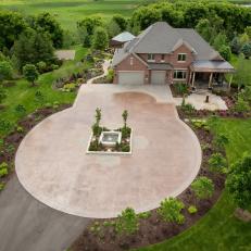 Grand Home Entrance Featuring Large Circular Driveway, Water Feature and Bordering Gardens 