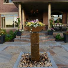 Artistic Column Water Feature With Floral Topper at Elegant Home Front Entrance 