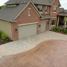 Spacious, Neutral Front Entrance With Large Driveway and Winding Walkway 