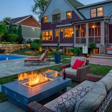 Fire Pit Lights Up This Spacious Backyard at Night