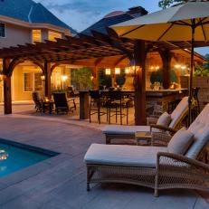 Covered Poolside Pavilion With Pergola Awning and Pendant Lighting 