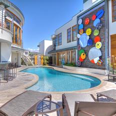 Contemporary Pool With Colorful Wall Art, Lounge Seating