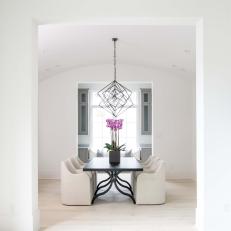White Modern Dining Room With Pink Orchid