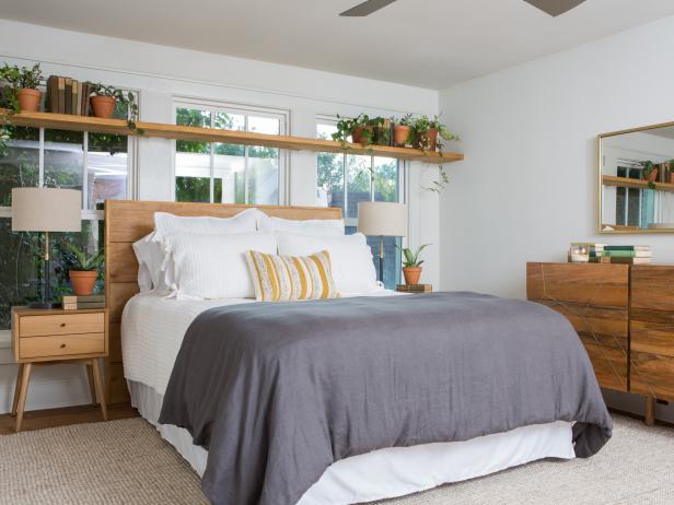 As seen on Fixer Upper, the renovated master bedroom in the Flip house has freshly painted walls and hardwood floors. (After #16)