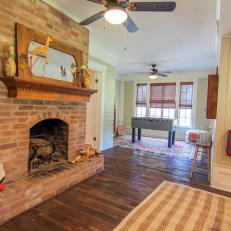 Brown Rustic Family Room with Brick Fireplace and Custom Mantel