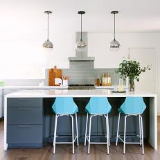 Gray and White Open Kitchen With Silver Pendants