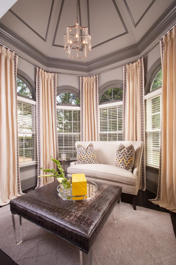 Warm, Gold-Infused Sitting Area Tucked Into Bay Window | HGTV