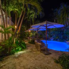 Tropical Backyard Oasis With Glowing Blue Pool