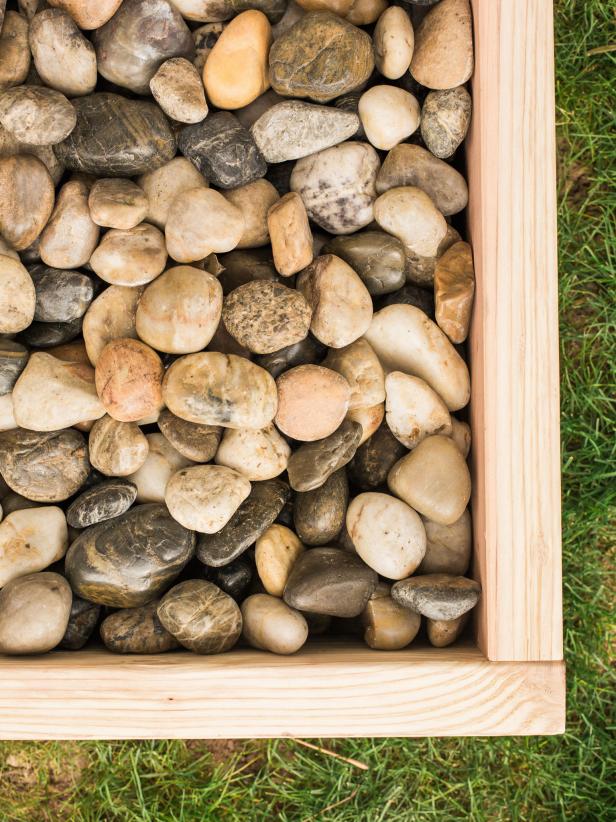 Step 5-  Add Stones
Put the box in place then fill with smooth river stones. Once the stones are in, you can’t move the box around, so make sure your location is near the entry AND you have easy access to a garden hose!
